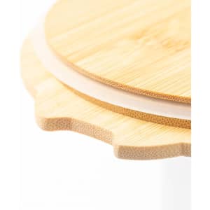 A bamboo lid with a smooth finish and scalloped edge, part of a lunch box design. The product has a natural look.