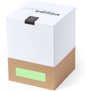 A boxed product with a white top and a brown base, featuring a logo and a blank green label.