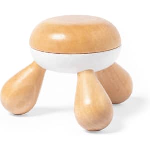 A wooden massager with a rounded top and three rounded legs, featuring a natural wood finish with a white band.
