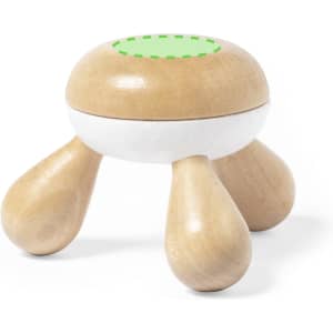 A wooden massager with three rounded legs and a green dotted pattern on top. It features a mix of natural wood and white finishes.