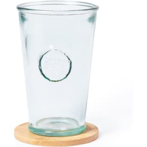 A glass drink tumbler with a round logo, resting on a circular bamboo coaster. The glass is transparent.