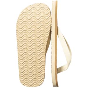 A pair of beige Yassir flip flops with a wavy sole and thin straps, featuring a simple logo on one strap.