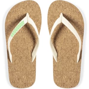 A pair of brown cork flip flops with white straps and a small green accent. They feature a logo on one strap.