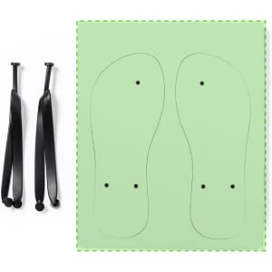Black flip flops with a green insole template, featuring two holes for straps. The pair includes black straps.