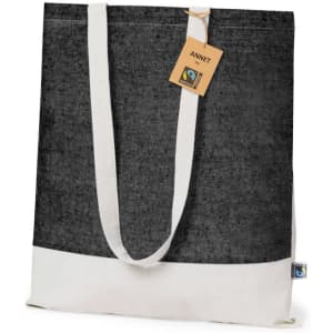 A black and cream tote bag with a Fairtrade tag and logo. The bag features long, sturdy handles.