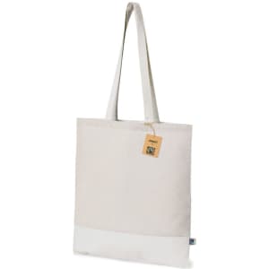 A beige tote bag with a white base and a shoulder strap, featuring a tag and a logo.