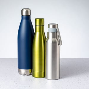 A drink bottle collection featuring a navy blue, a vibrant green, and a stainless steel insulated bottle, all with lids.