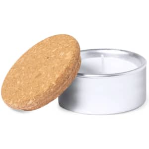 A silver tin candle with a cork lid, featuring a white wax interior.