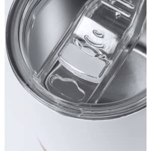 A close-up of a clear lid for an insulated white coffee mug, featuring a drinking opening and sliding closure.