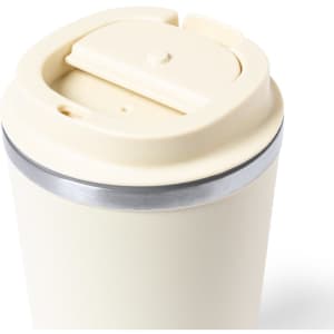 An insulated travel mug in cream with a silver band and a lid for easy drinking.