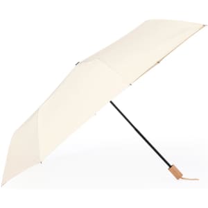 A cream umbrella with a black pole and a tan handle, featuring a minimalist design and a branding logo.