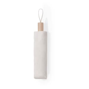 A beige Nouka Umbrella with a wooden handle and a loop for hanging. It has a minimalist design.
