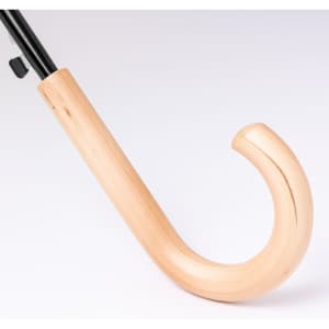 A tan wooden handle of an umbrella with a curved design, featuring a black shaft.