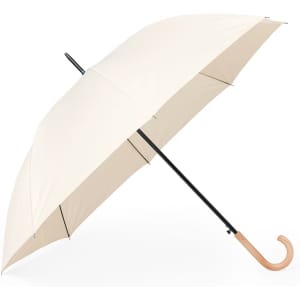A cream umbrella with a black handle and a wooden curved end, featuring a simple design.