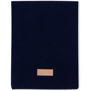 A navy Kinar Scarf made of soft fabric, featuring a small logo on a leather patch.