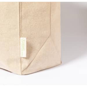 A beige tote bag made from recycled cotton with a visible logo on the side.