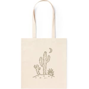 A beige tote bag featuring a cactus design with a moon and plants, including a logo.