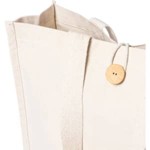 A cream tote bag with a wooden button closure and sturdy fabric handles. Features a simple and minimalist design.