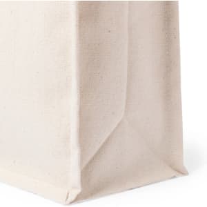 A cream tote bag with a structured base, featuring a fabric texture and straight edges. It has a logo on the side.