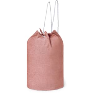 A pink drawstring duffel bag with a textured appearance and white drawstrings.