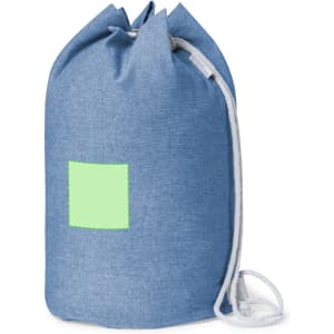 A blue drawstring bag featuring a white cord and a blank green patch for customization.