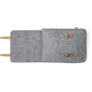 A grey felt backpack with brown leather straps and metal buckles, featuring a simple and minimalistic design.