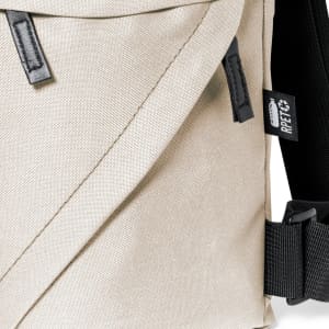 A beige backpack with a textured fabric, featuring black straps and a logo tag on the side.
