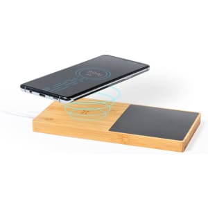 A wireless charger in a bamboo base with a black charging pad, featuring a smartphone above it.