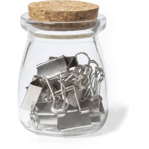 A glass jar with a cork lid containing silver paper clips. The jar has an elegant, simple design.