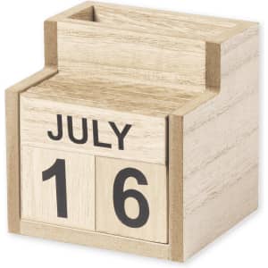A wooden desk calendar pencil holder in natural tones with movable date and month blocks. Features a branding logo.