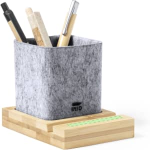 A grey felt pencil holder with several pens and pencils, resting on a wooden base. It features a logo.