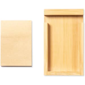 A bamboo notepad holder alongside a notepad, featuring natural wood tones and a minimalist design.
