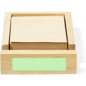 A bamboo notepad holder with a stack of plain, cream-coloured notepad sheets and a green label area.