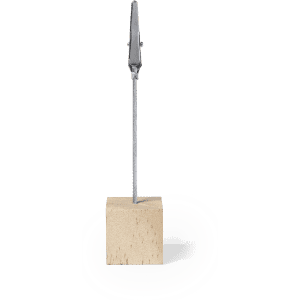A silver clip attached to a wooden block, designed for holding papers. The clip features a sleek design.