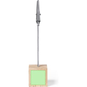 A wooden clip display stand with a silver metal clip on top and a green square area on the base.