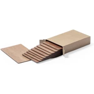 A set of brown business cards displayed in a kraft cardboard box, with several cards partially pulled out.
