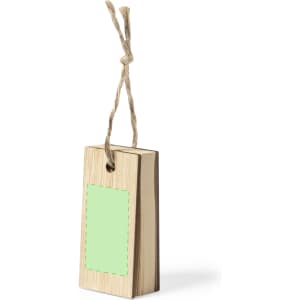 A wooden notepad with a green placeholder area, hanging from a natural twine string. The notepad has a simple design.