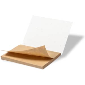 A sticky notepad with a brown base and white sheets, partially peeled back, featuring a simple design.