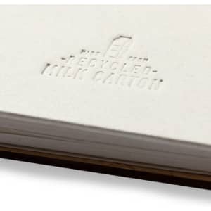 A white notebook featuring a textured design, made from recycled milk cartons, with an embossed logo.