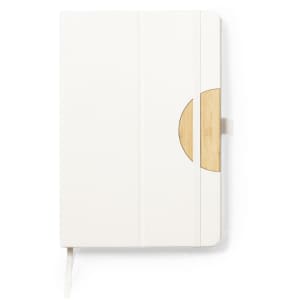 A notebook with a white cover and a wooden circular accent, featuring an elastic closure and a ribbon bookmark.