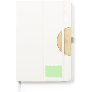 A white notebook with a wooden accent and a green patch, featuring an elastic band closure and a logo.