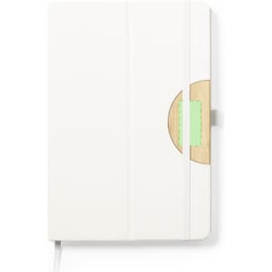 A white notebook with a wooden accent and a pastel green detail, featuring an elastic strap and a ribbon bookmark.