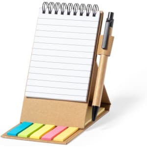 A sticky notepad holder featuring a brown base, a spiral notebook, coloured sticky notes, and a pen.