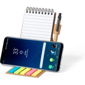 A notepad holder with a spiral binding, sticky notes in various colours, and a pen, alongside a smartphone.