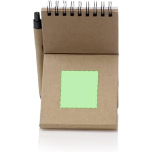 A sticky notepad with a brown cover and a green sticky note inside, featuring a pen attached to the side.
