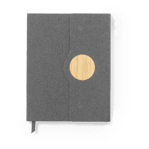 A grey notepad with a bamboo circle detail, featuring a soft cover and a ribbon bookmark. It includes a logo.