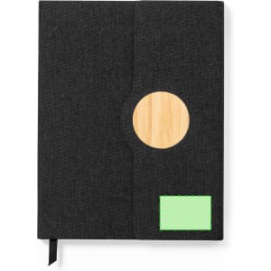 Aquo Notepad features a dark grey cover with a bamboo circle and a green label. It includes a black ribbon marker.
