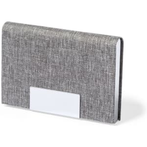 A grey business card holder made of textured fabric with a metallic-styled slot. It features a branding logo.
