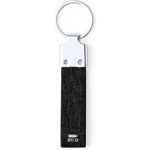 A black keyring with a textured fabric strap and a metal ring. It features a logo on the strap.