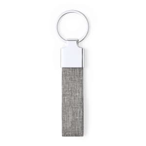 A grey fabric keyring with a metallic ring attachment. It features a sleek design and has a branding logo.